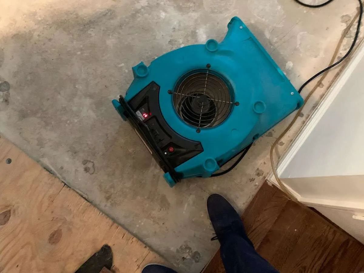 Air mover drying subfloor during Commercial Water Damage Restoration in Oak Park